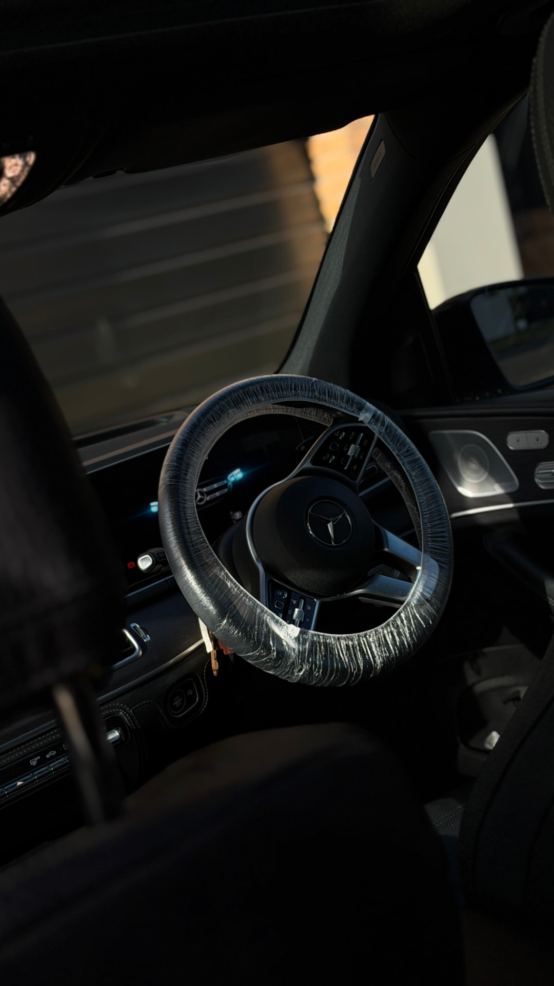Protected steering wheel inside a Mercedes-Benz during an interior detail